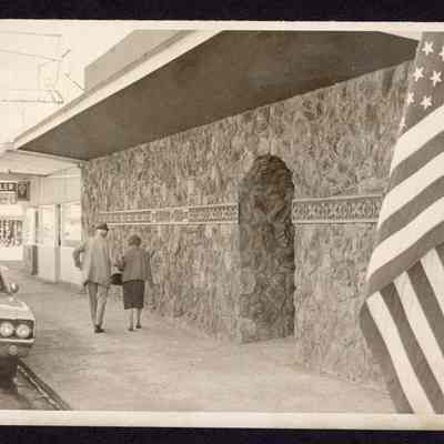Photograph of a couple walking downtown, Springfield, Oregon, undated