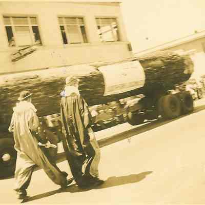 Photograph of Large Log on Log Carrier, Two Clowns on Street, Springfield Industrial Parade, Springfield, OR, 1941