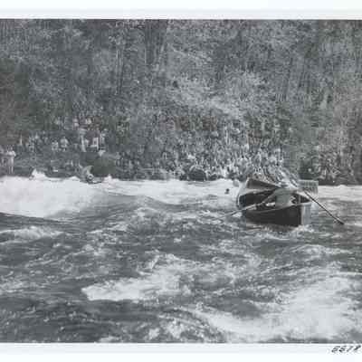 Photograph of a patrol boat rescuing a participant of the White Water Parade, McKenzie River, Oregon, circa 1969