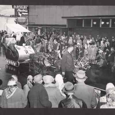 Photograph of Santa in his sleigh with four reindeer.