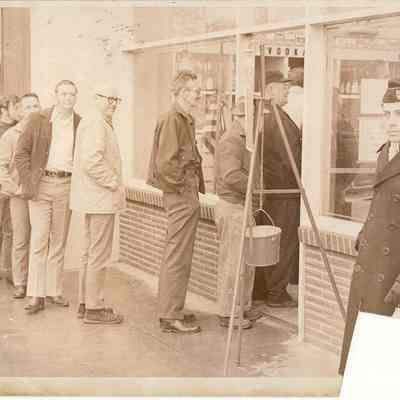 Photograph of Salvation Army bell ringer, with line outside State Liquor Store, Springfield Oregon