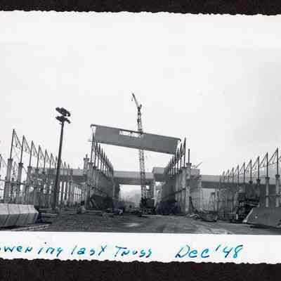 Photograph of the lowering the last truss