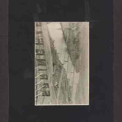 Photograph mounted on poster board. View of Springfield, Oregon from behind the Springfield sign on Willamette. Date unknown.