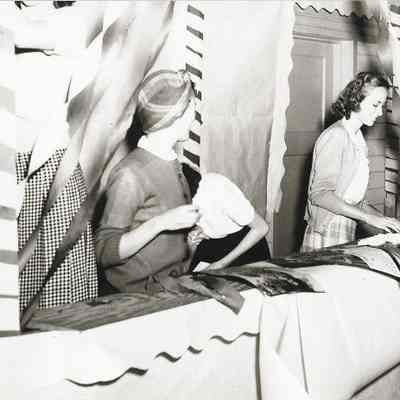 Photograph of some girls setting up a a booth at the Springfield High carnival, Springfield, Oregon, circa 1940s