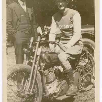 Photograph of Bill Davis senior on his motorcycle and a Harley Davidson factory man, undated