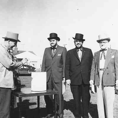 Photograph of four men adding items to Oregon Centennial time capsule, 1959