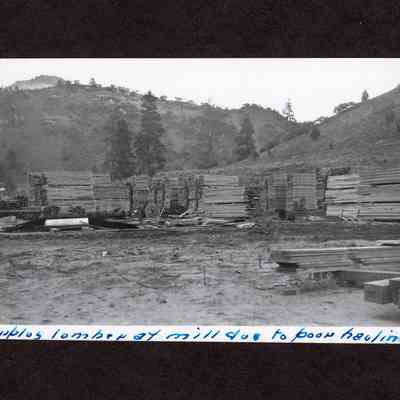 Photograph of surplus lumber at mill due to poor hauling