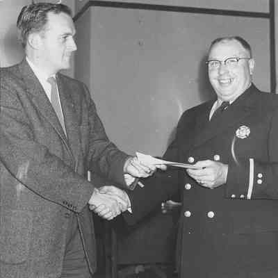 Photograph of fire chief Harry Kreiger receiving an award, date unknown