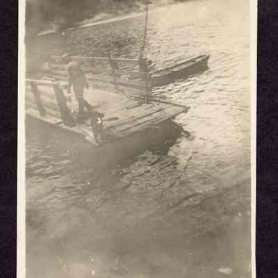 Photograph of person and dog on river ferry, undated