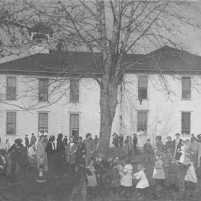 Photograph of Mill Street School, candid shot of students at play in yard, Springfield, Oregon, date unknown.