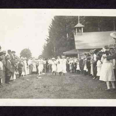 Photograph on postcard of single women's race at the lodge picnic at the Camp Creek School