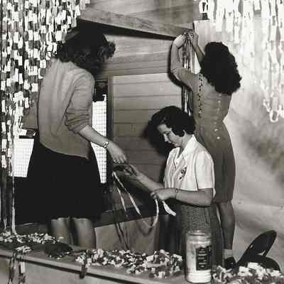 Photograph of four unidentified students setting up for a Springfield High 1940s carnival