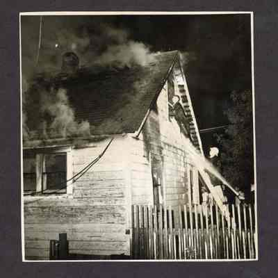 Photograph, nighttime house fire, date and location unknown.