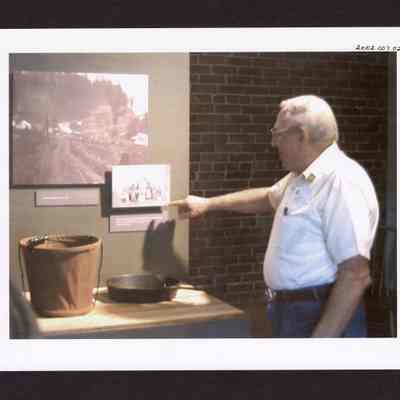 Photograph of man at Springfield Museum's "Working in the Woods" Exhibit, Springfield, Oregon, 2000