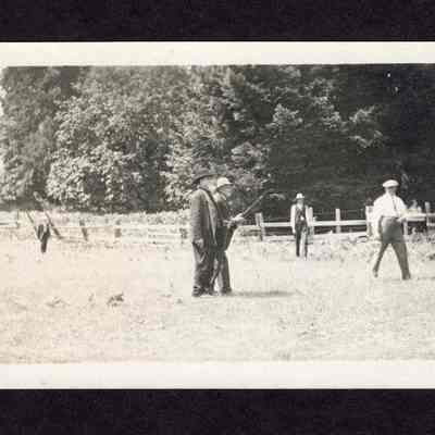 Photograph on postcard of men in a field playing ball, from the lodge picnic at the Camp Creek School