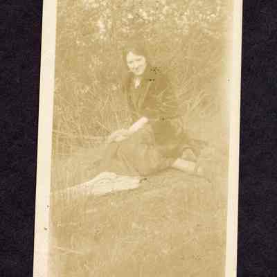 Photograph of unknown woman sitting on grass
