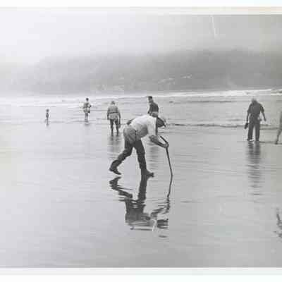 Photograph of people prospecting on the beach, Oregon