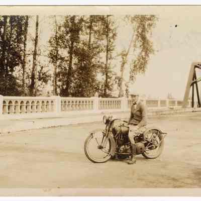 Photograph of Bill Davis on his motorcycle, at a bridge in Springfield, 1926