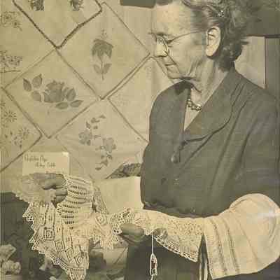 Photograph of Ella Griffith Holding Doilies at Golden Age Hobby Table Exhibit, Circa 1960