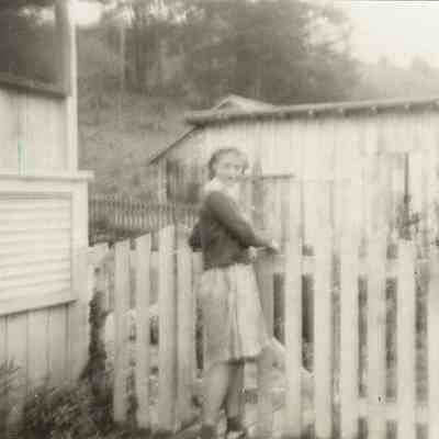 Photograph of Eileen Pollard behind her house on C Row, Wendling, Oregon