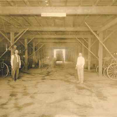 Photograph of two men inside White Elephant Livery stable, Springfield, Oregon, circa 1906
