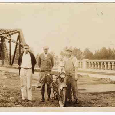Photograph of Bill Davis, two other men, a dog and his motorcycle, at the new bridge in Springfield, 1926