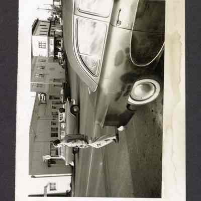 Photograph of a car and man in front of Springfield Beauty Shop, Springfield, Oregon, undated