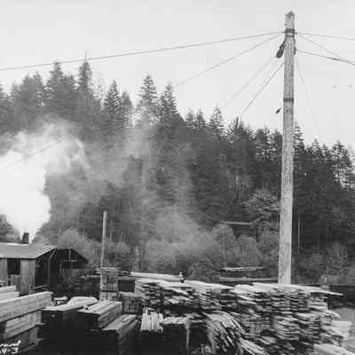 Photograph of Stacked Lumber at a Rural Mill, Date Unknown