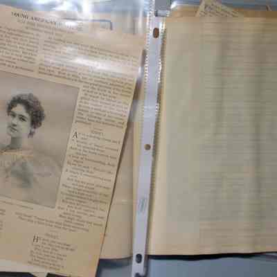 Page 32 and 33, showing page 33 with newspaper scrapes covering it