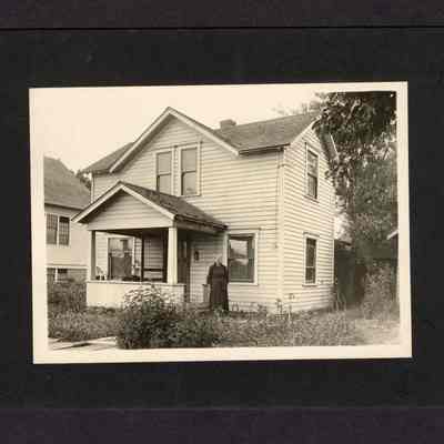 Photograph of Grandma Hyland in front of a house