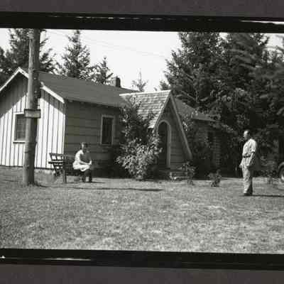 Photograph of House people and automobile, date unknown