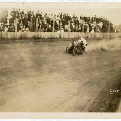 Photograph of motorcyclist Bill Davis senior and speed clerk on a speedway, undated
