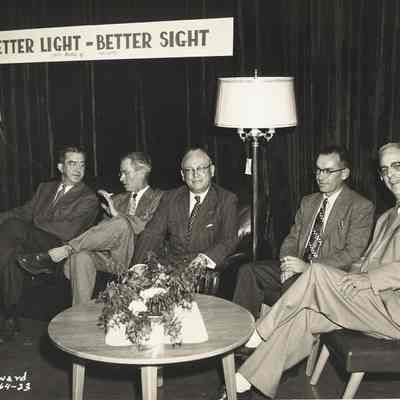 Photograph of men seated at display at Springfield Electric Appliance Show, 1954