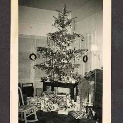 Photograph of a christmas tree inside a house, undated