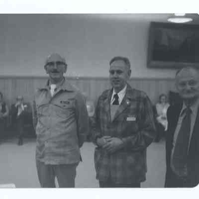 Photograph of the 35 year emblems of H.R. Fox, J.W. Mertz, O.O. Gildow, S.A. McMullen, South Pacific Railroad, 1977