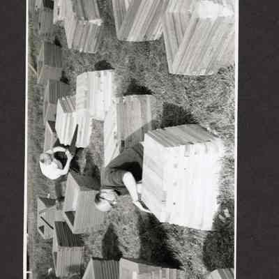 Photograph of two men building planters, Date and Location Unknown