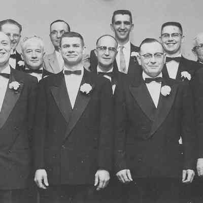 Photograph of twelve men, sporting corsages, at Masonic Lodge, Eugene, Oregon, date unknown