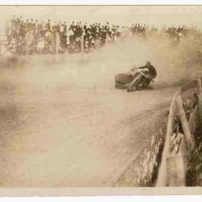 Photograph of motorcyclist Bill Davis senior and speed clerk on a speedway, Fairgrounds, Eugene, undated