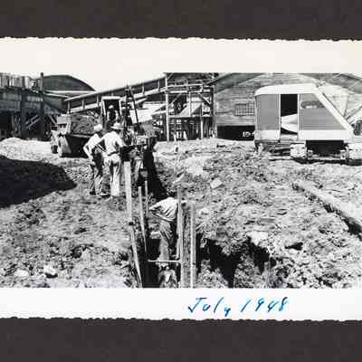 Photograph of the filling of the old log pond at Booth-Kelly Lumber Mill