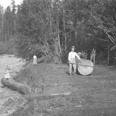 Photograph of four men and two women next to the Mohawk River, Oregon
