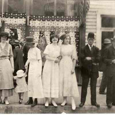 Photograph of four women, seven men and one child