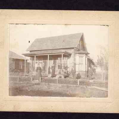 Photograph of the Swift Family outside their home, 5 people
