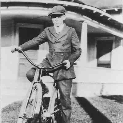 Photograph of young Lowell Noble with his bike