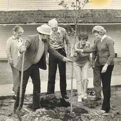 Photograph of Thurston Grange Group Planting a Tree In Front of Thurston Grange, Springfield, OR, Date Unknown