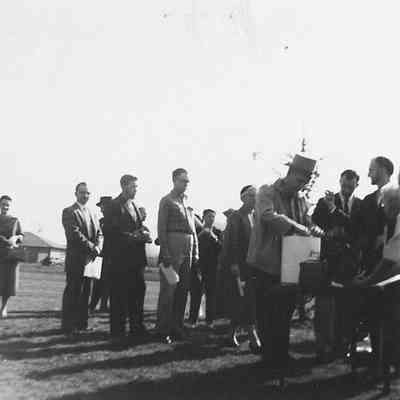 Photograph of people lined up to add items to time Centennial time capsule, 1959