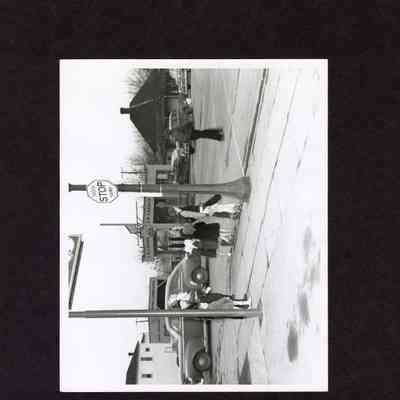Photograph, People crossing street, date and location unknown.