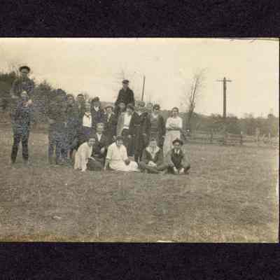 Photograph of 20 people outside on grass