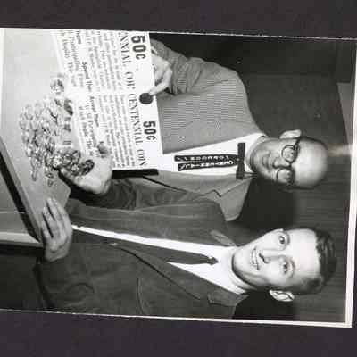 Photograph of 2 men selling Oregon Centennial coin, circa 1985