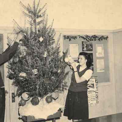 Photograph of two Springfield High School students decorating tree, circa 1940s