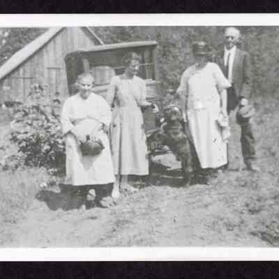 Photograph of four people in front of a car, Springfield, Oregon, circa 1920s